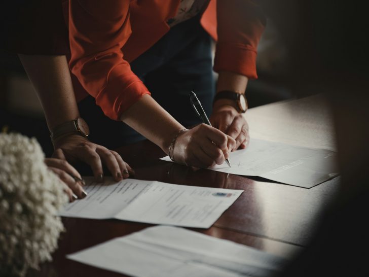 Construction loan rates - A person signing paper.