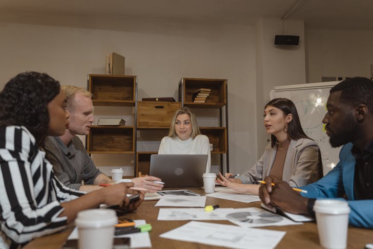 What is the difference between a job and a career - A group of busy businesspeople in meeting.